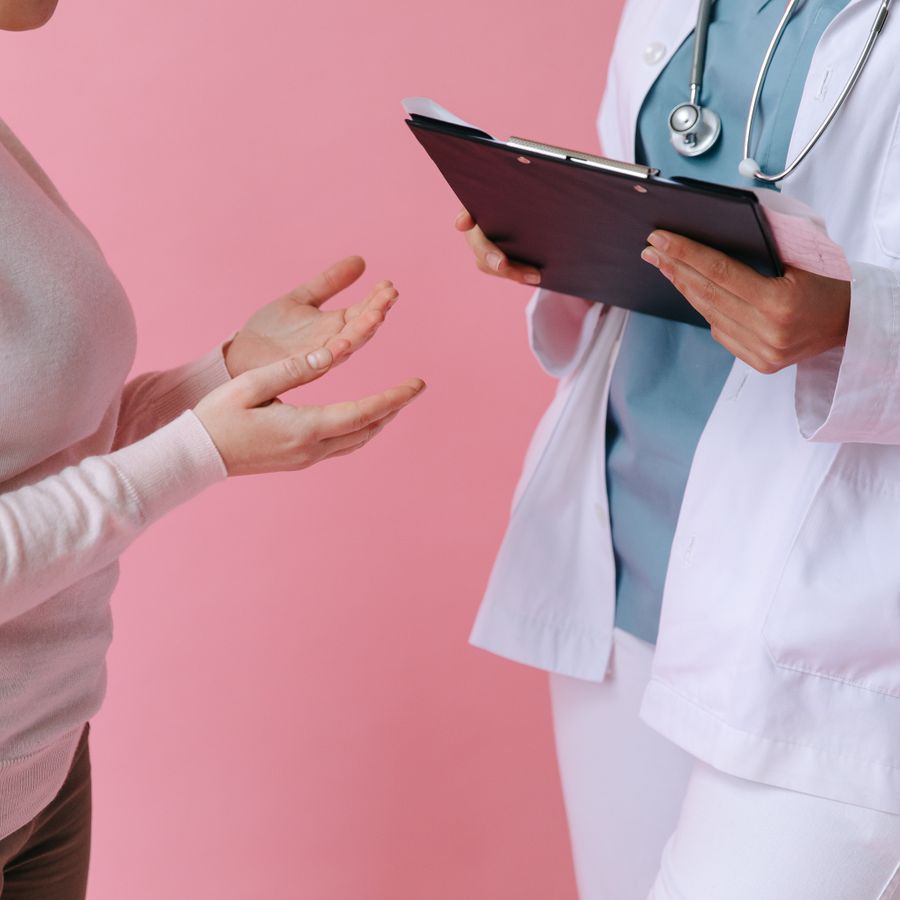 An Indian doctor consulting a patient in a bright clinic