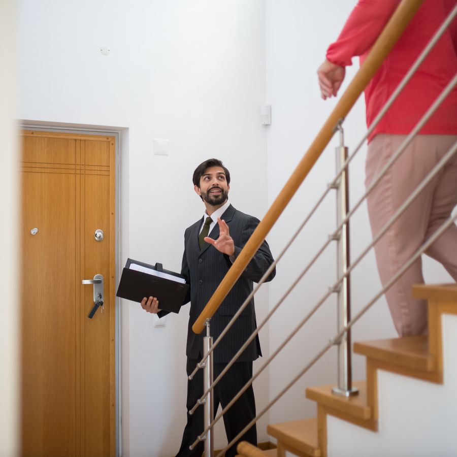A property dealer showing a new flat to a family in India