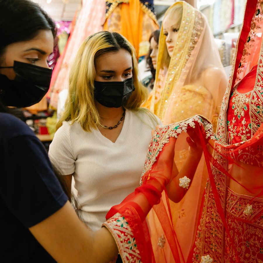 Customers browsing colourful sarees in an Indian textile shop