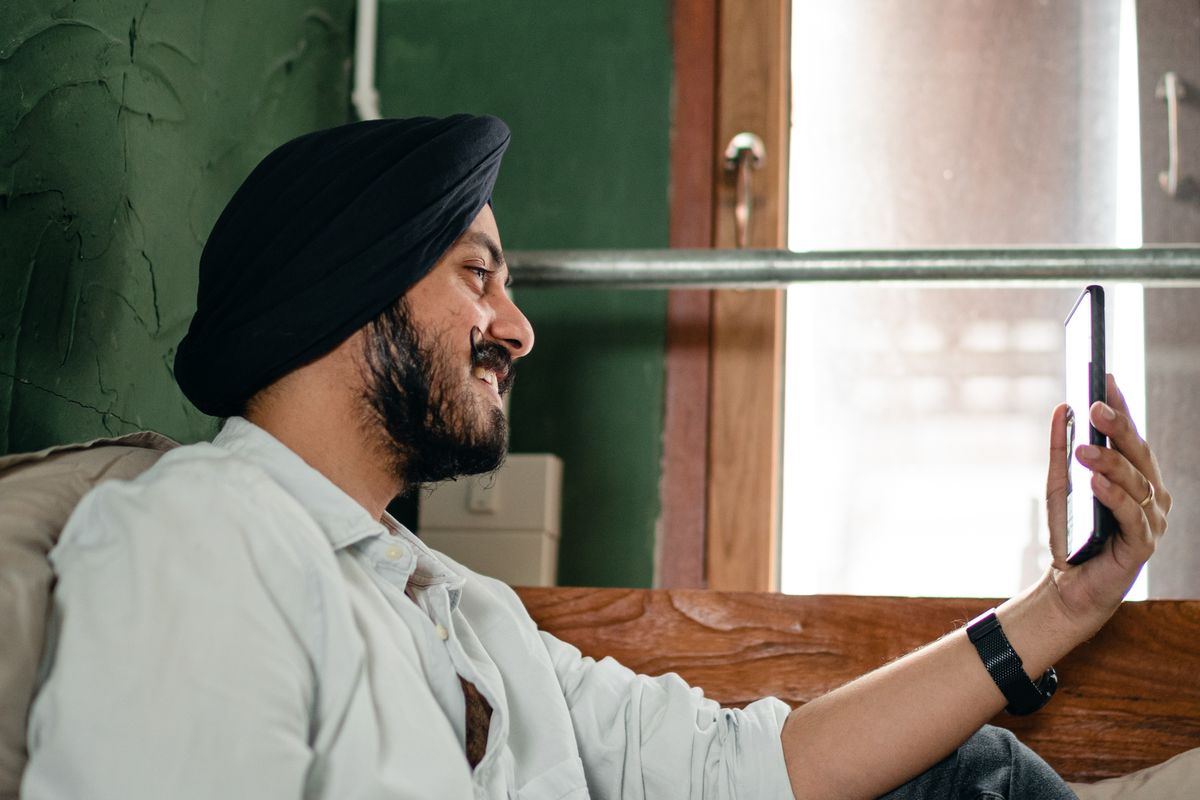 A happy Indian customer on a video call with support