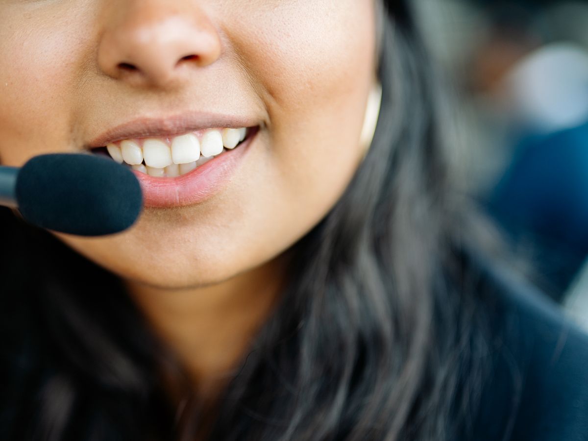 An Indian support agent with a headset, answering customers